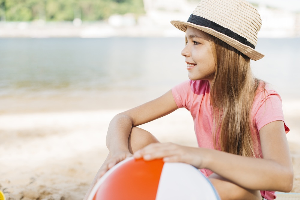 smiling-girl-with-inflatable-ball-beach.jpg